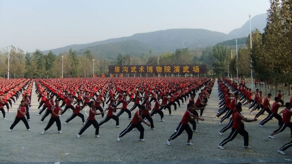 Rows of students practise in the training centre’s outdoor square.